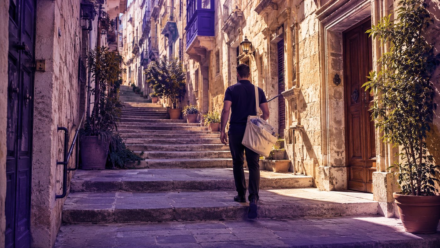 A PostPro distributor delivering quietly along a traditional Maltese street